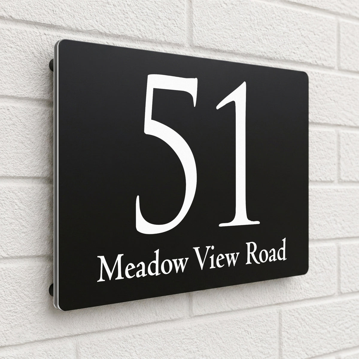 Black composite house sign personalised with '51 Meadow View Road' in an elegant serif font