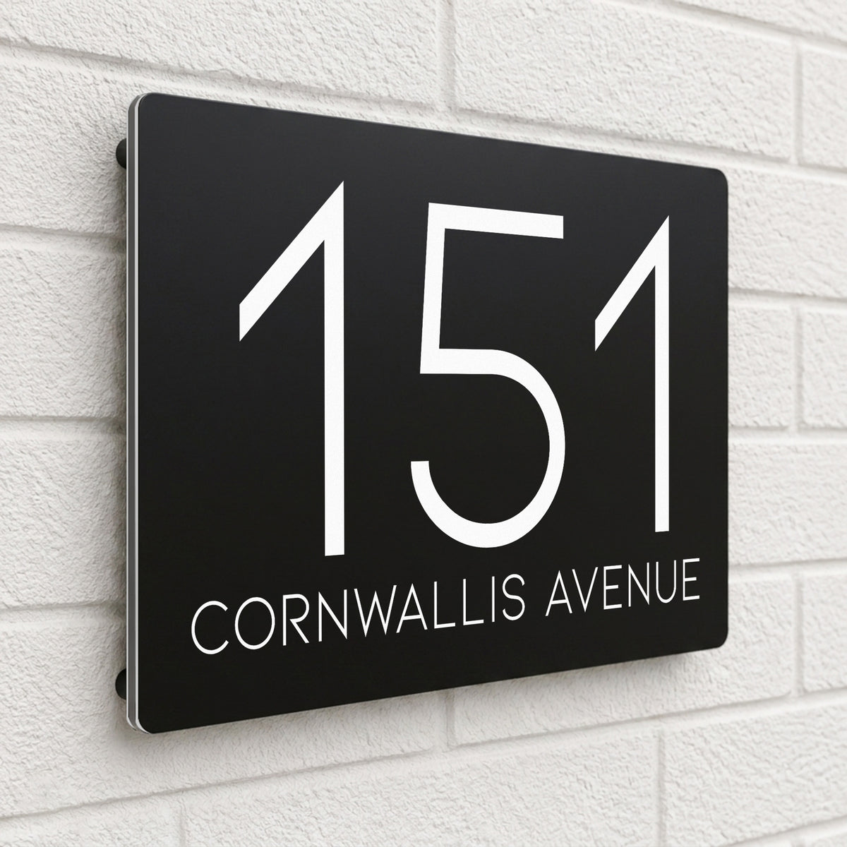 Black composite house sign personalised with '151 Cornwallis Avenue' in a thin modern typeface