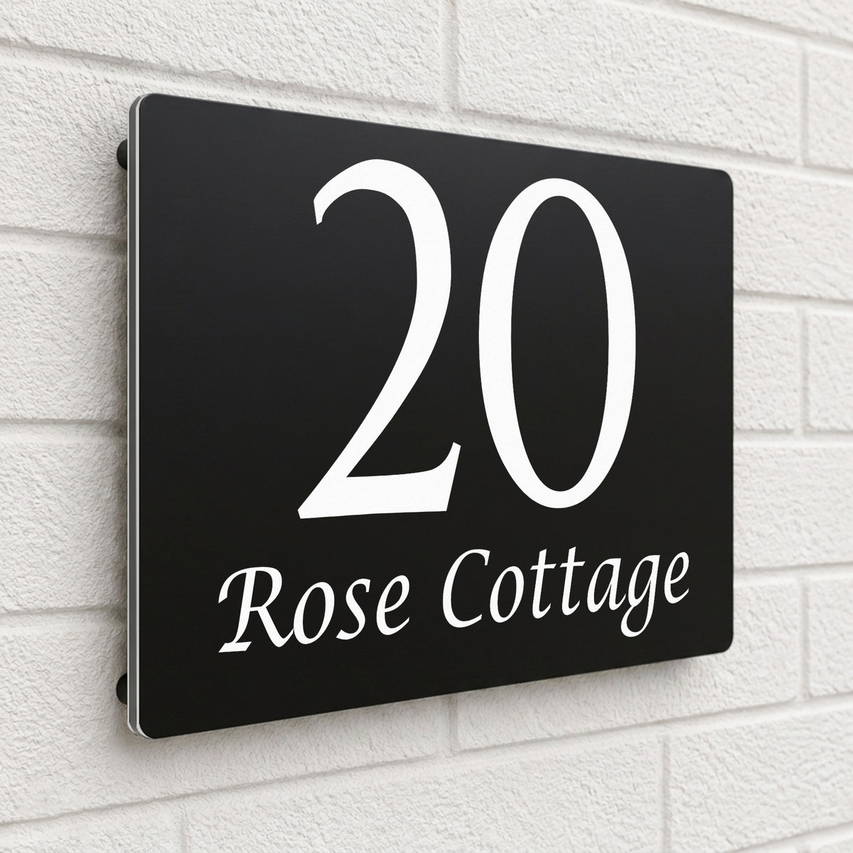 Black composite house sign personalised with '20 Rose Cottage' in an elegant serif font
