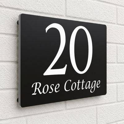 Black composite house sign personalised with '20 Rose Cottage' in an elegant serif font
