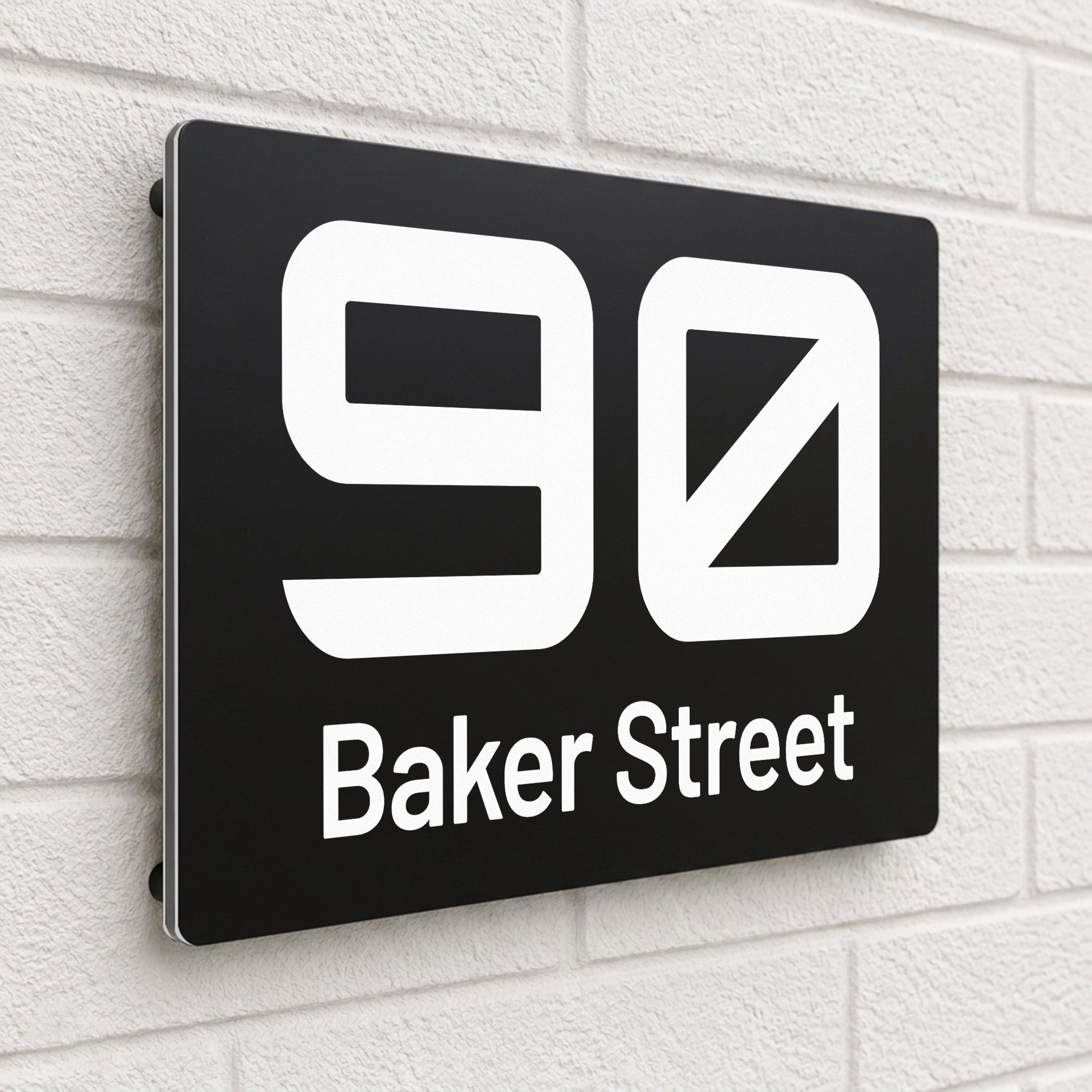 Black composite house sign personalised with '90 Baker Street' in a bold rounded typeface