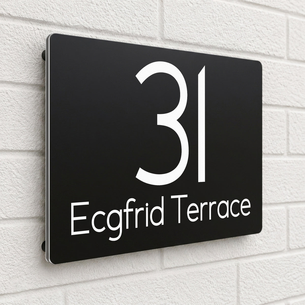 Black composite house sign personalised with '31 Ecgfrid Terrace' in a rounded modern font