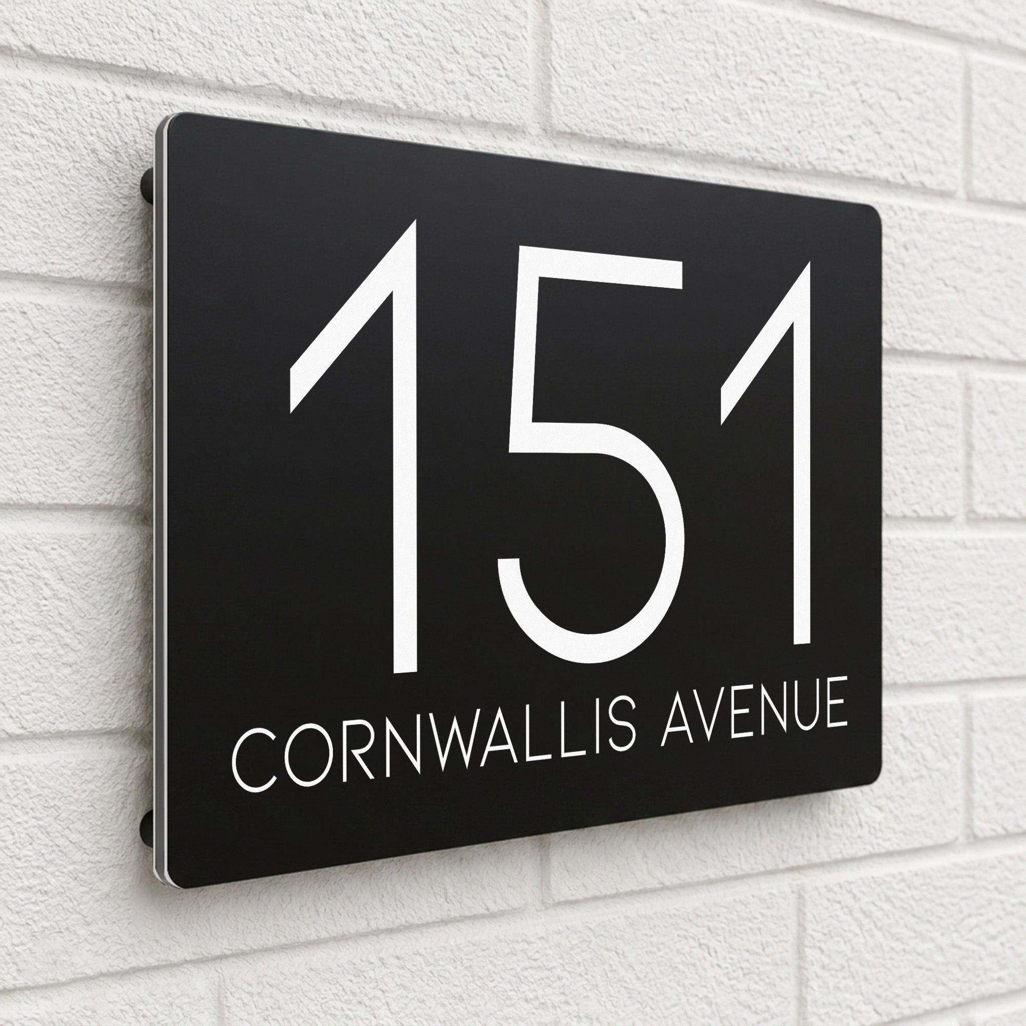 Black composite house sign personalised with '151 Cornwallis Avenue' in a thin modern typeface