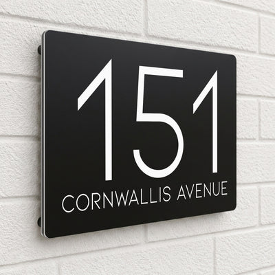 Black composite house sign personalised with '151 Cornwallis Avenue' in a thin modern typeface