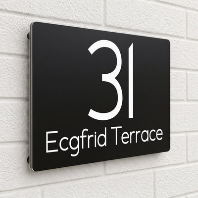 Black composite house sign personalised with '31 Ecgfrid Terrace' in a rounded modern font