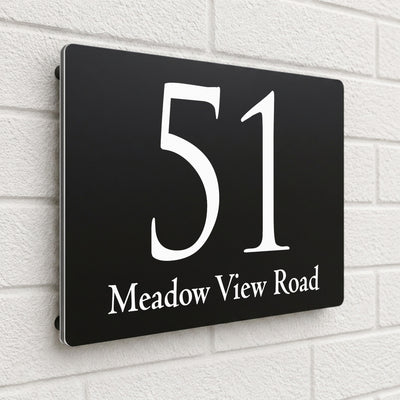 Black composite house sign personalised with '51 Meadow View Road' in an elegant serif font