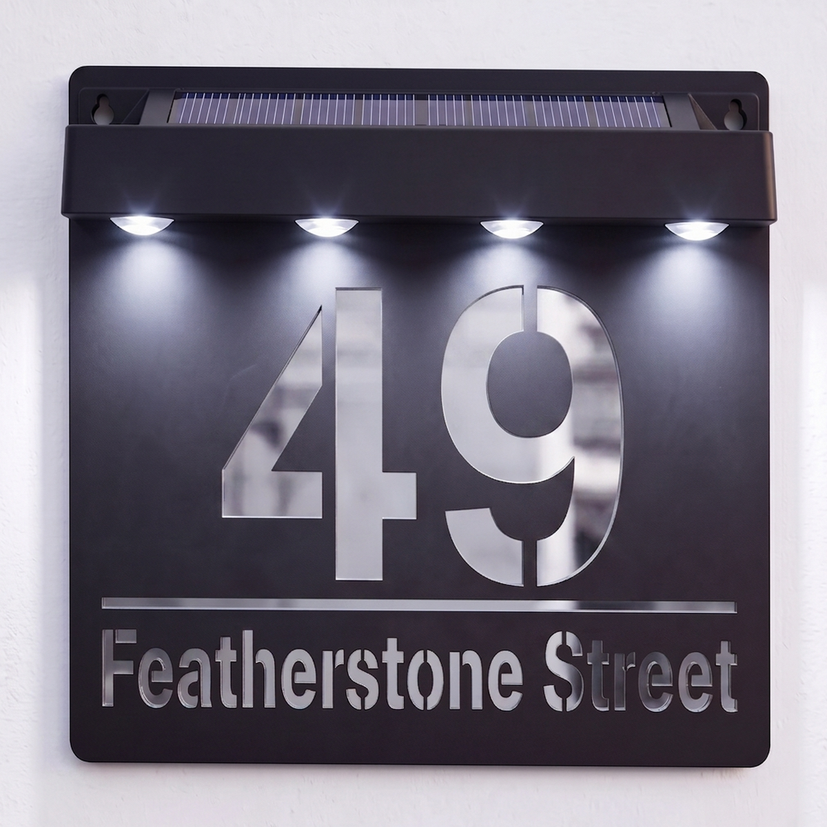 Detail shot of the mirror-effect lettering on a Black solar powered house sign