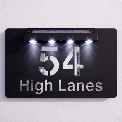 Personalised Black solar powered house sign shown with a custom house number and text (alternate example)